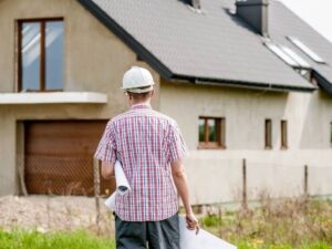 Survey stakes marking residential property lines for setback planning before home redevelopment.
