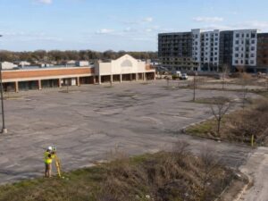 Aerial view of an older shopping center site being evaluated for conversion into a residential development