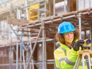 Construction surveyor checking building layout on an active development site in Fairfax Virginia